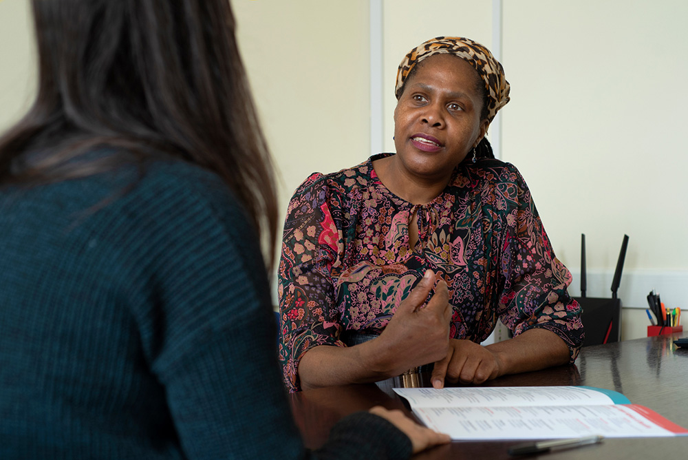 A carer talks to a support officer in a one-to-one meeting