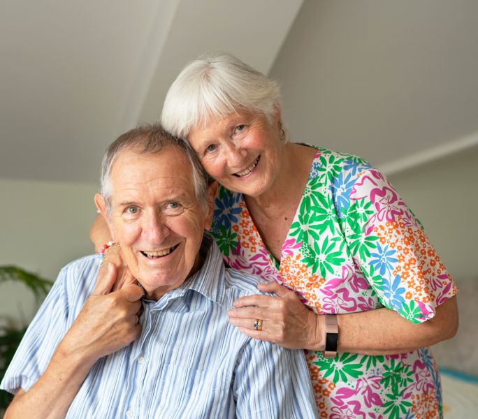 A carer hugs her husband