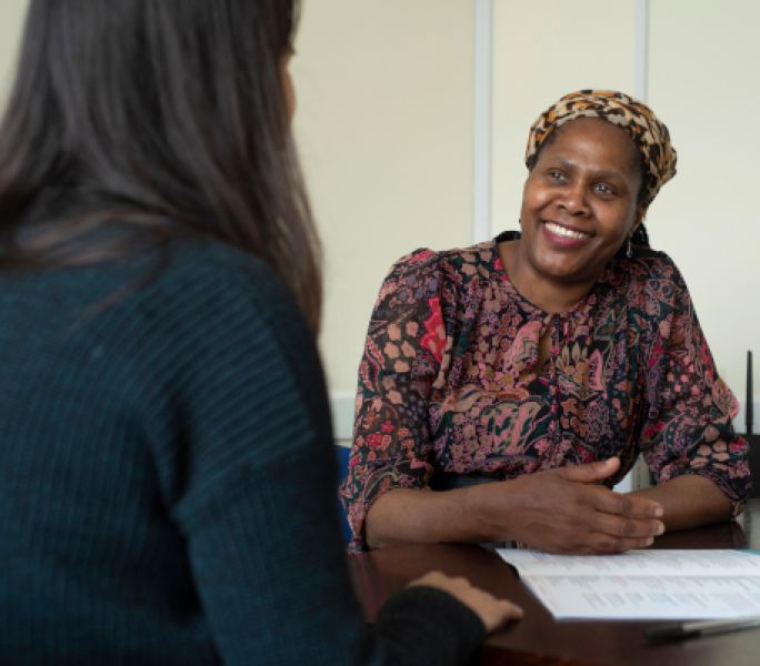 A black carer talks to a Carers Support Officer