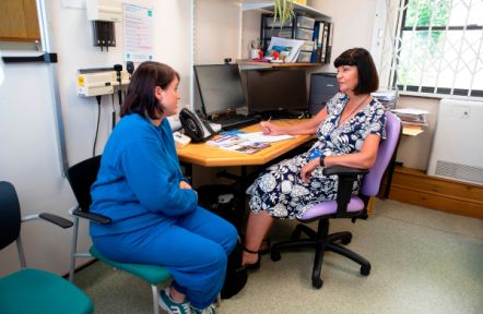 A member of the GP team in discussion with a carer at a local GP surgery