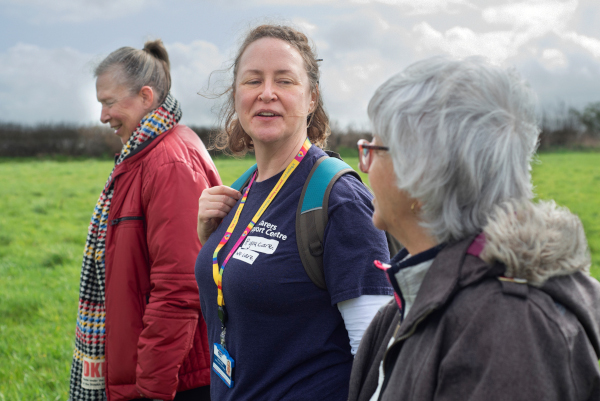 Our support worker walking and talking with two carers