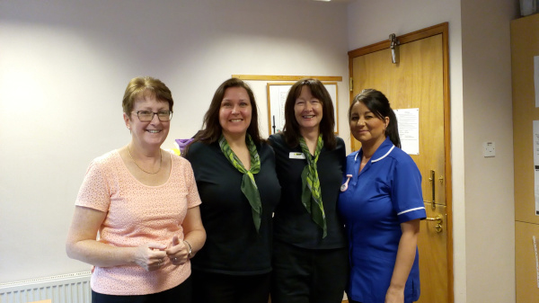 A group of friendly looking health professionals smile at the camera