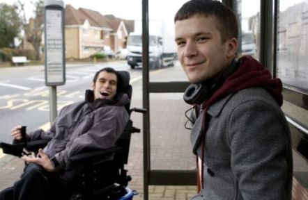 A young carer at a bus stop with his brother