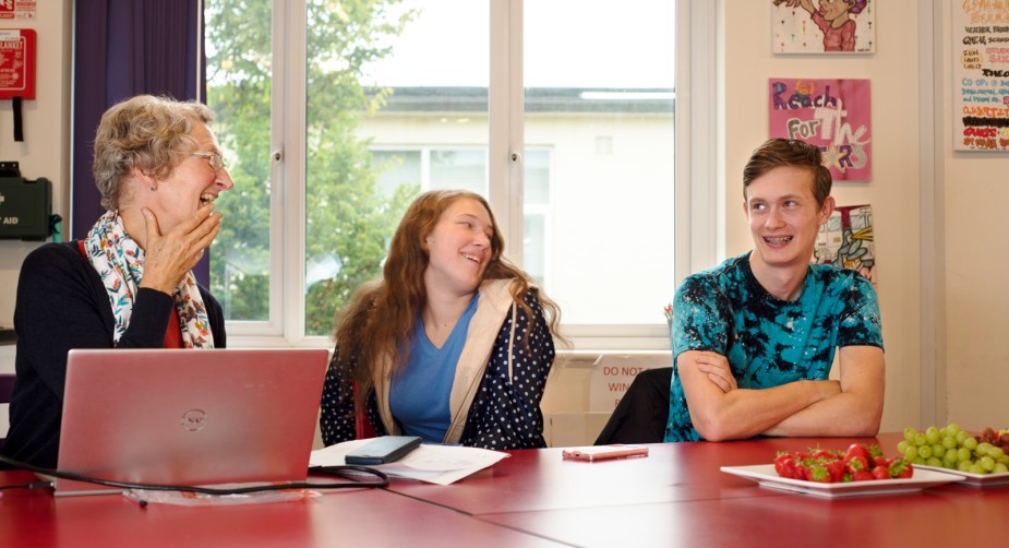 The head of the Young Carers' service having a laugh with two young carers at a Young Carers' Voice meeting