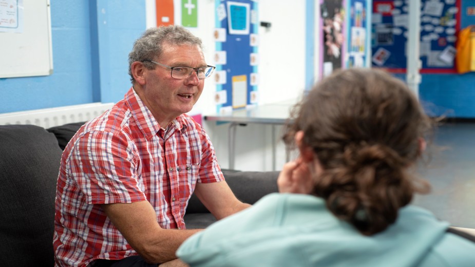 A carer worker talking with a young carer