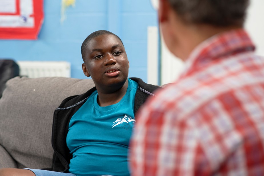 A young carer talks things through with a care worker